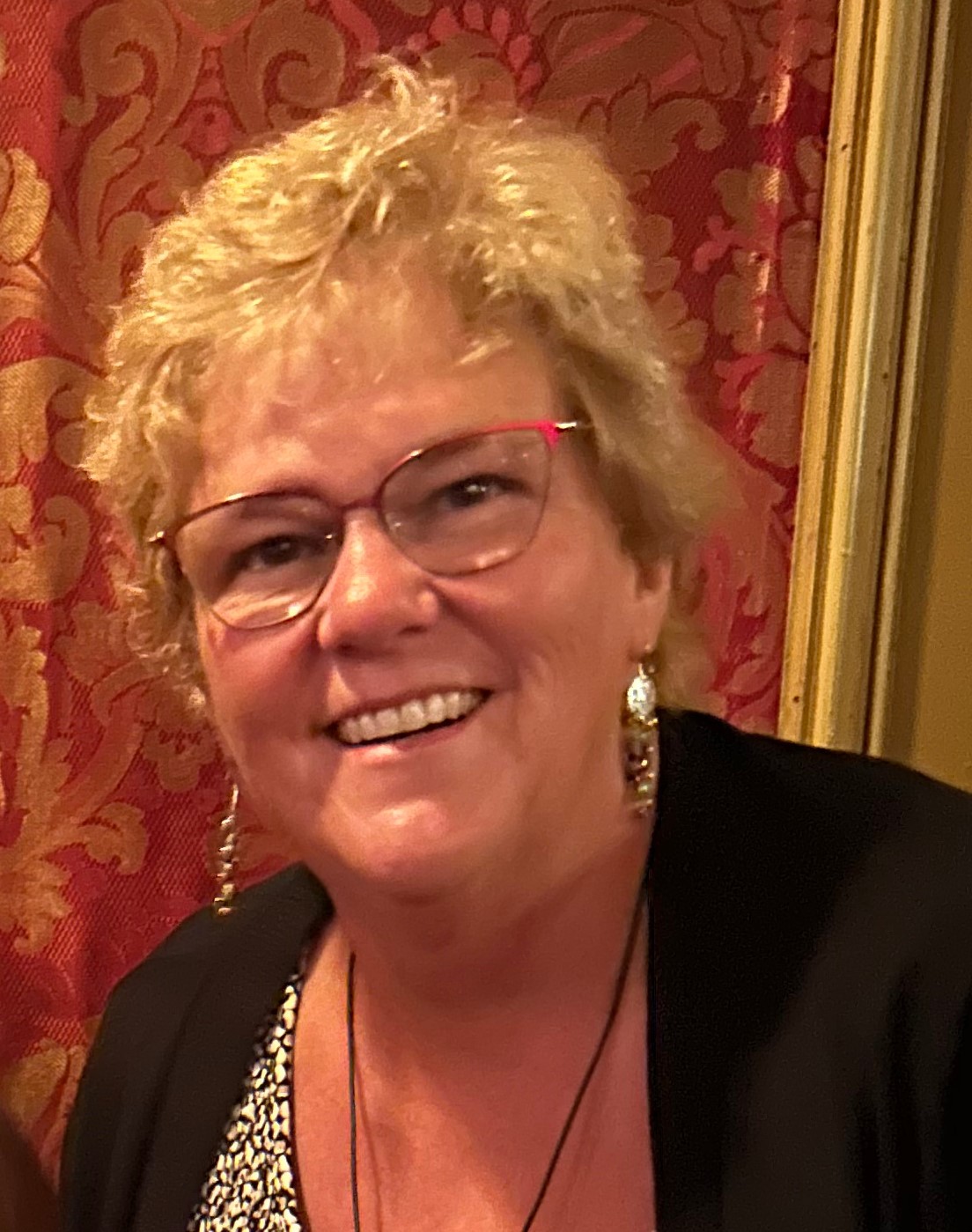 smiling woman in glasses and black sweater