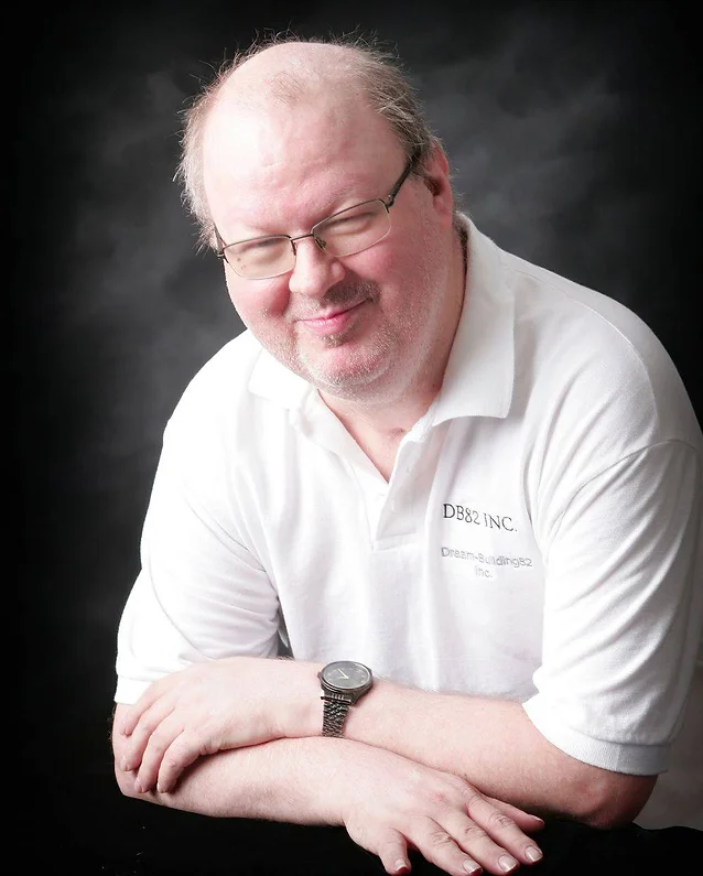 Man in glasses and white shirt smiling