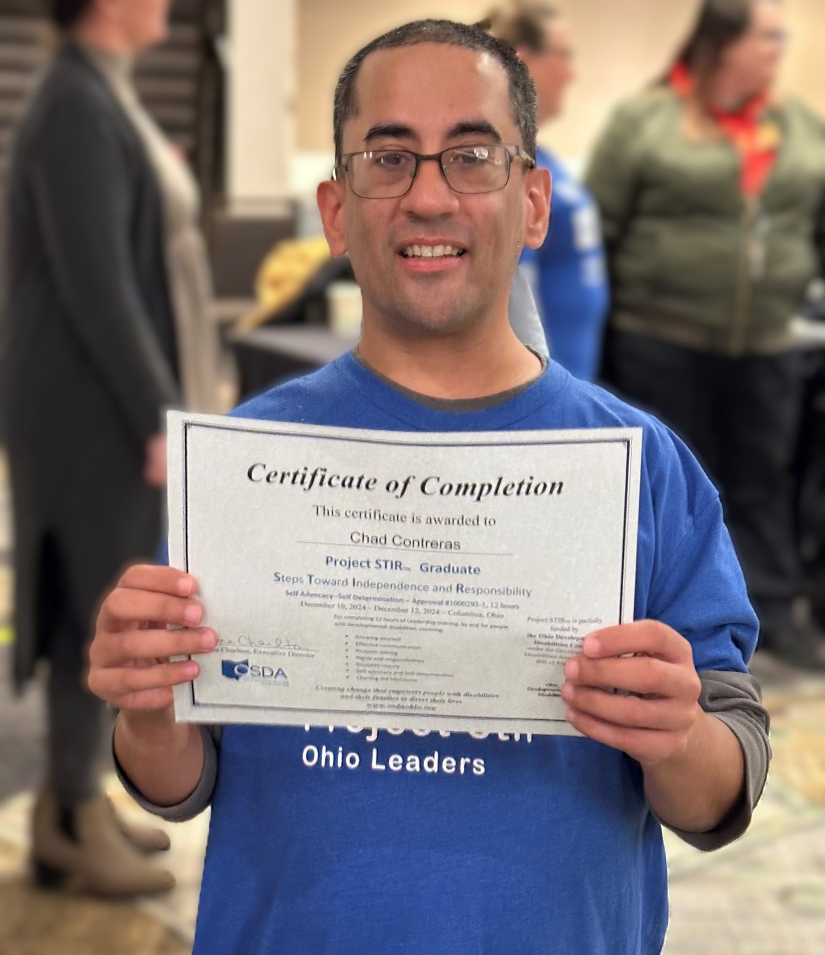 Smiling man holding certificate